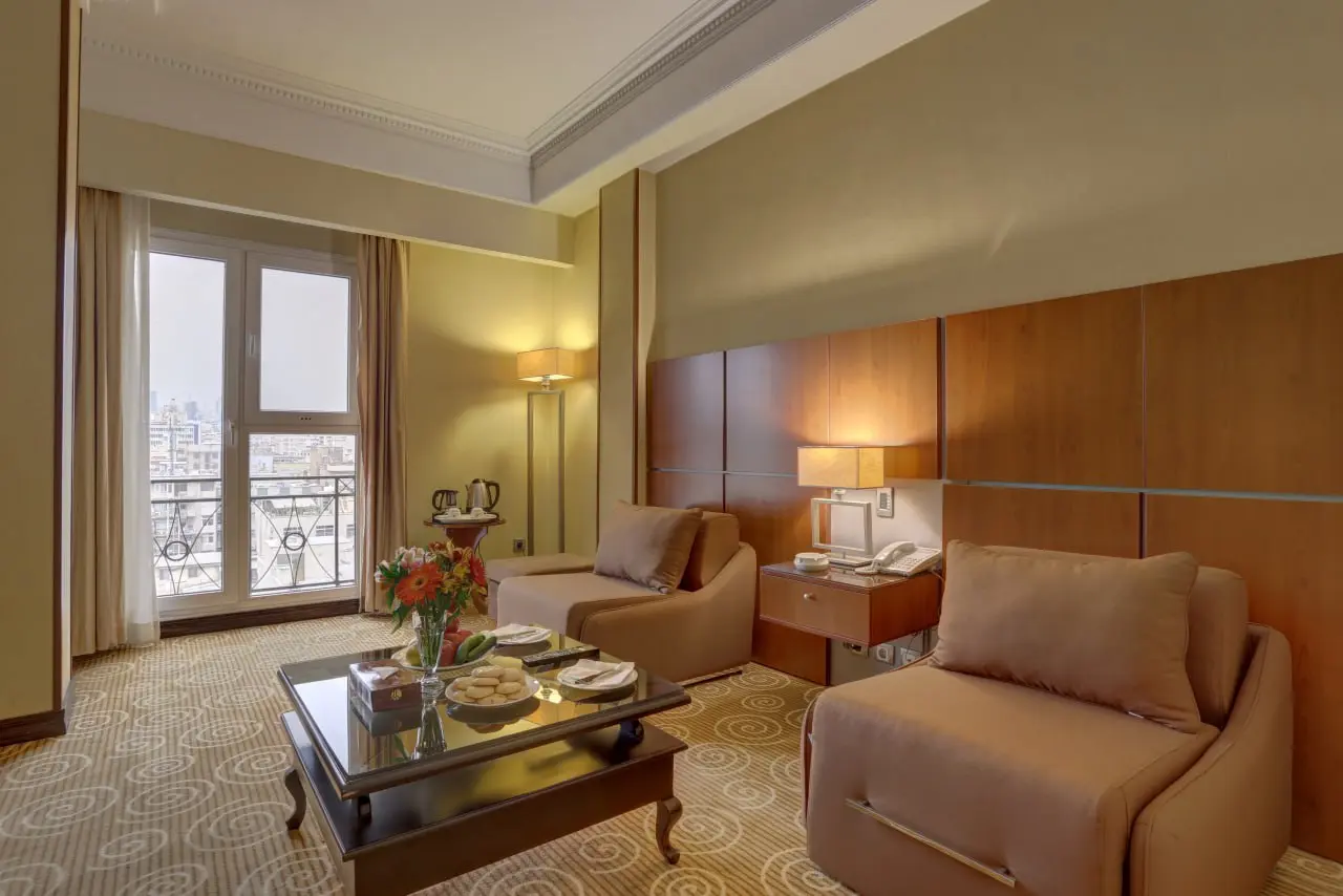 Spacious deluxe room at Tehran Grand Hotel 2 with modern amenities for patient recovery